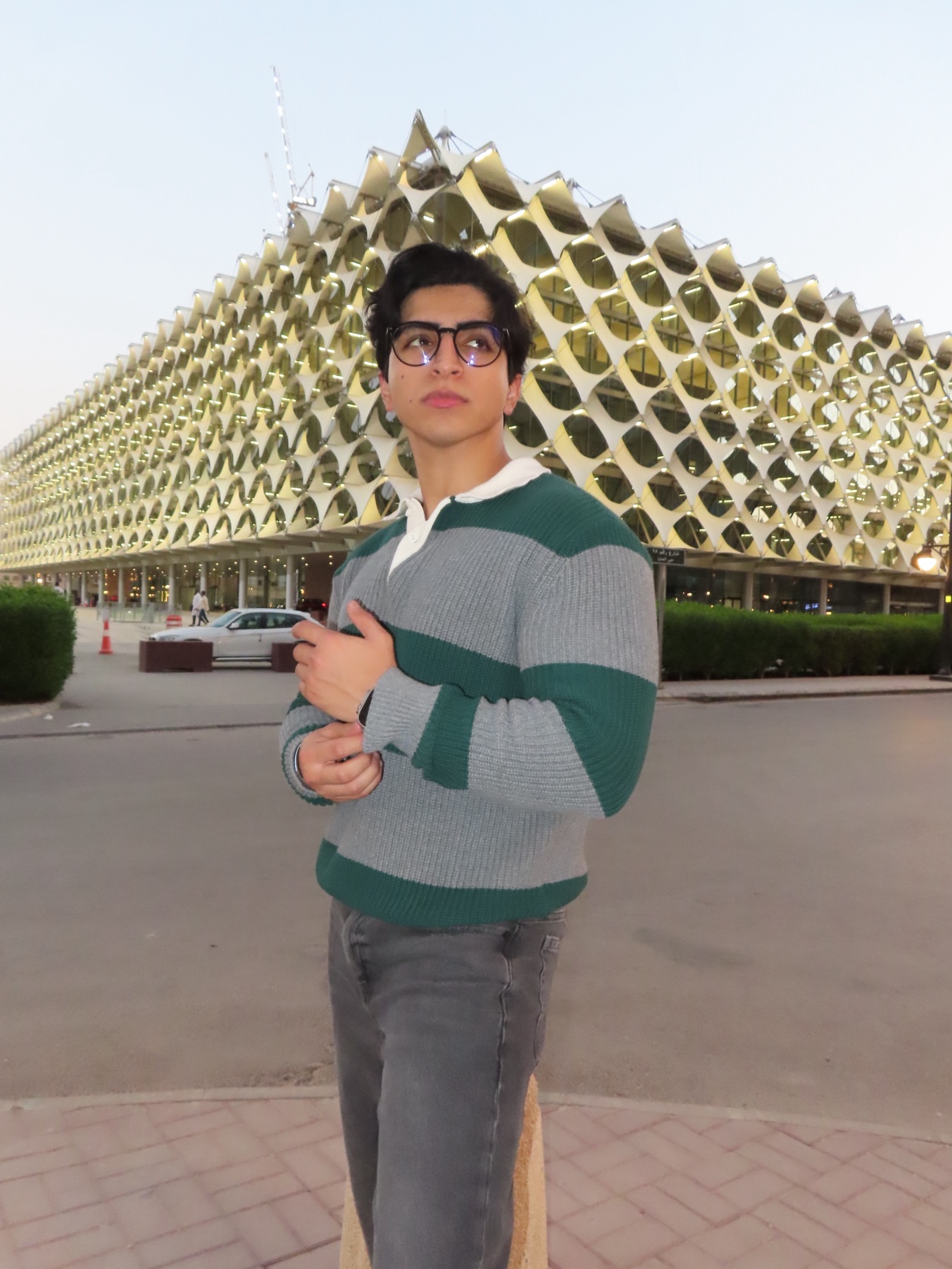 Abdullah in a grey and green fashion look